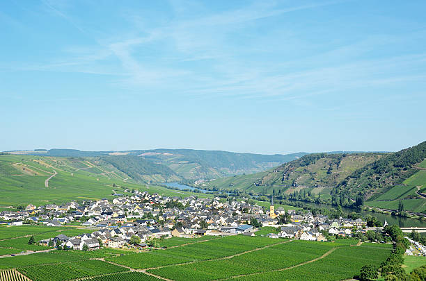 View From The Mosel River To Bernkastel-Kues Germany On A Beautiful Sunny Summer Day With A Clear Blue Sky And A Few Clouds