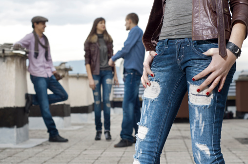 Young people wearing jeans shot on the roof of a building