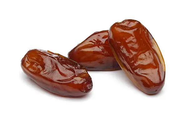 Dried dates on white background