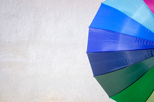 Multicolored fabric background of a summer umbrella.