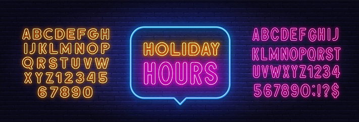 Holiday Hours neon sign in the speech bubble on brick wall background. Pink and yellow neon alphabets.