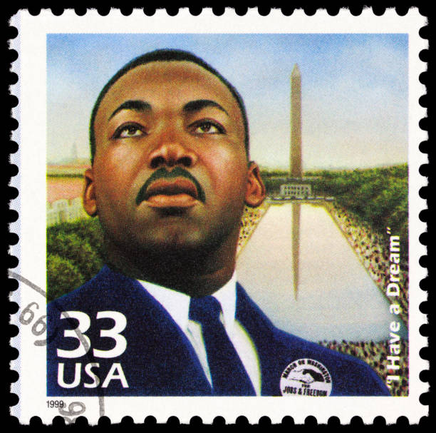 Martin Luther King Jr "Seattle, USA - June 23, 2012: A 1999 USA postage stamp with an image of Martin Luther King, Jr. King is depicted wearing a badge that reads: MARCH ON WASHINGTON FOR JOBS & FREEDOM, and in the background is the Washington Memorial and a large crowd of people. The stamp commemorates the August 28, 1963 demonstration in Washington, D.C." human rights photos stock pictures, royalty-free photos & images