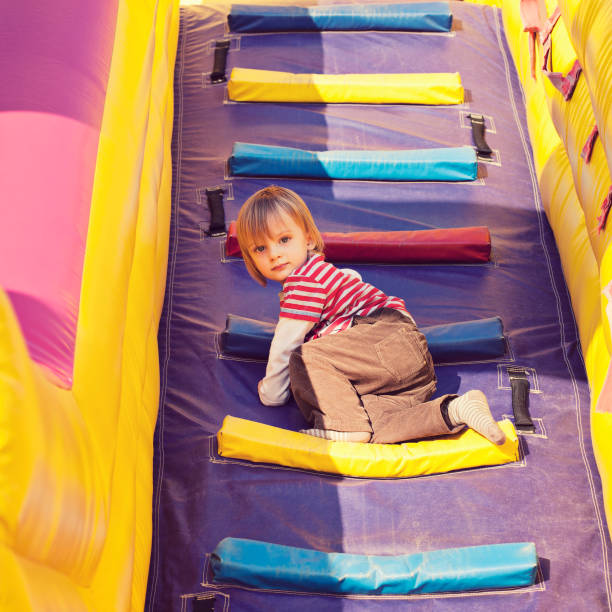istock Child climbing on inflatable playground 171309885
