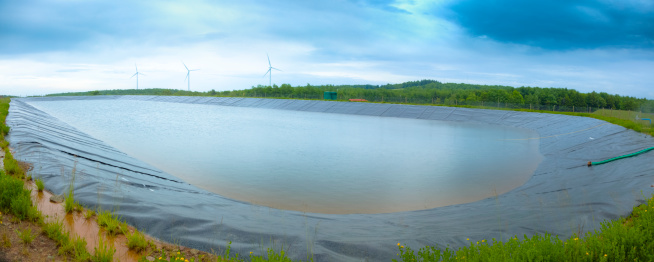 Containment pond for a producing Marcellus shale well site.  This pond is used to evaporate the contaminated water that is constantly carried to the surface by the natural gas.I invite you to view some of my other Alternative Energy and Industrial images: