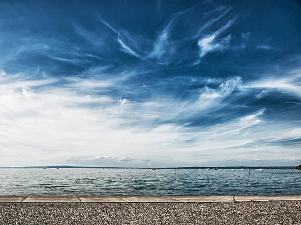 lake constance with dramatic sky focus on front on the pebbles bodensee stock pictures, royalty-free photos & images