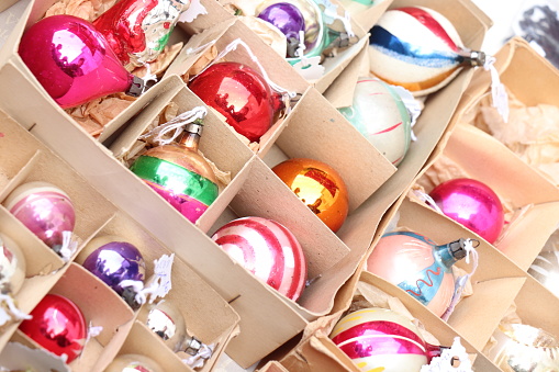 Collection of colorful vintage christmas baubles in a carton box