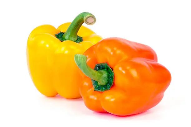 Orange and Yellow bell peppers isolated on white background.