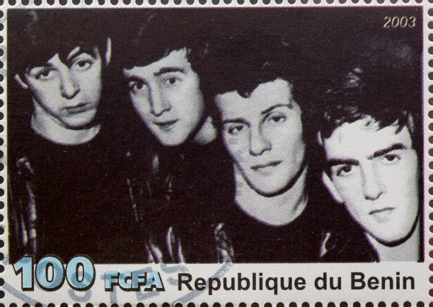 The Beatles "Newcastle, United Kingdom - September 18, 2012: The Beatles featured on a Postage Stamp from the Republique du Benin" beatles stock pictures, royalty-free photos & images