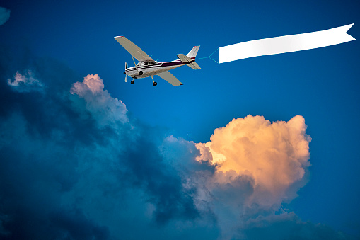 Airplane with banner at sunset time