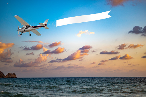 Airplane with banner at sunset time