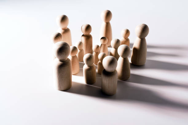 istock Group of confused grouped people, represented by wooden figures, isolated in studio on white background. 1713109826