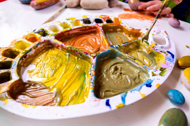 istock Girl painting with acrylic paint developing her creativity in an art school. 1713109838