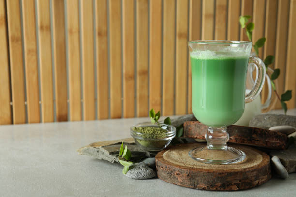 istock Cup of matcha latte and accessories for making against bamboo background 1713110905