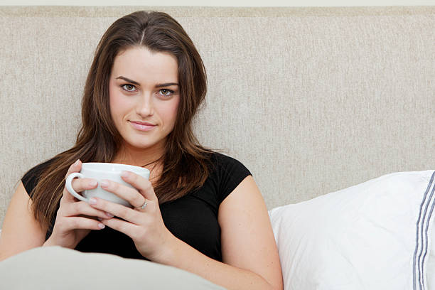 istock Beautiful Woman in Bed with Mug 171311194