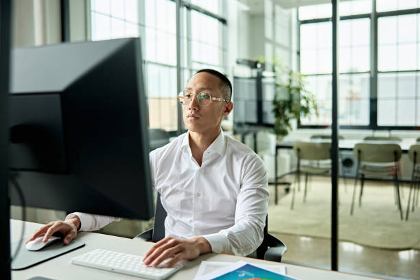 istock Focused young Chinese businessman working on computer 1713113085