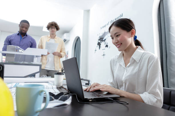 istock woman architects using laptop building design in modern office with blueprint on table. Professional female thinking sketching planning idea of project build a home. 1713113111