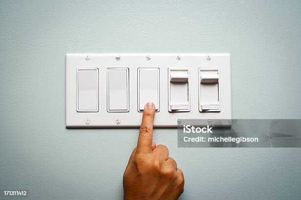 Womans Hand Turning Off The Light Stock Photo - Download Image Now - Turning On Or Off, Light Switch, Electric Light