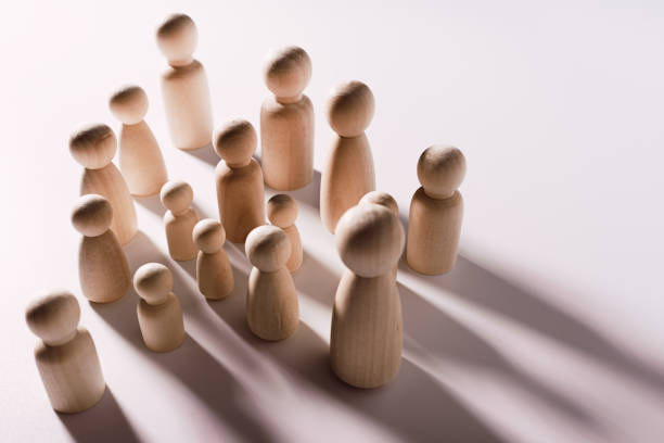 istock Figures in the shape of people casting shadows on a flat surface. 1713114207