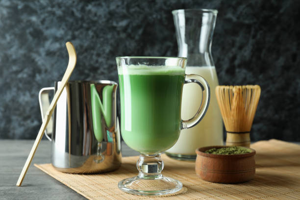 istock Cup of matcha latte and accessories for making on gray textured table 1713114721