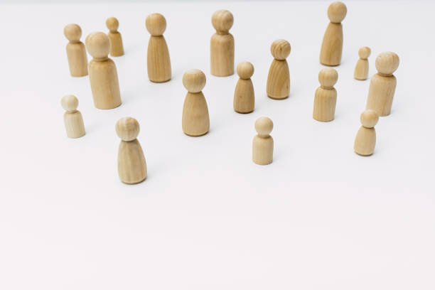 istock Group of confused grouped people, represented by wooden figures, isolated in studio on white background. 1713115847