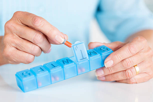 Senior Woman Holding Daily Pill Container. stock photo