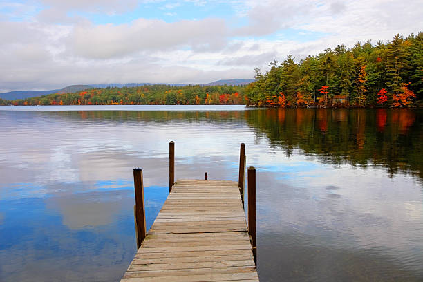 Autumn on Squam Lake  located in central New Hampshire, USA, south of the White Mountains. Photo taken on a calm morning during the peak fall foliage season. New Hampshire is one of New England's most popular fall foliage destinations bringing out some of  the best foliage in the United States