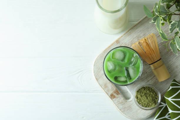 istock Matcha latte and accessories for making on white wooden table 1713117610