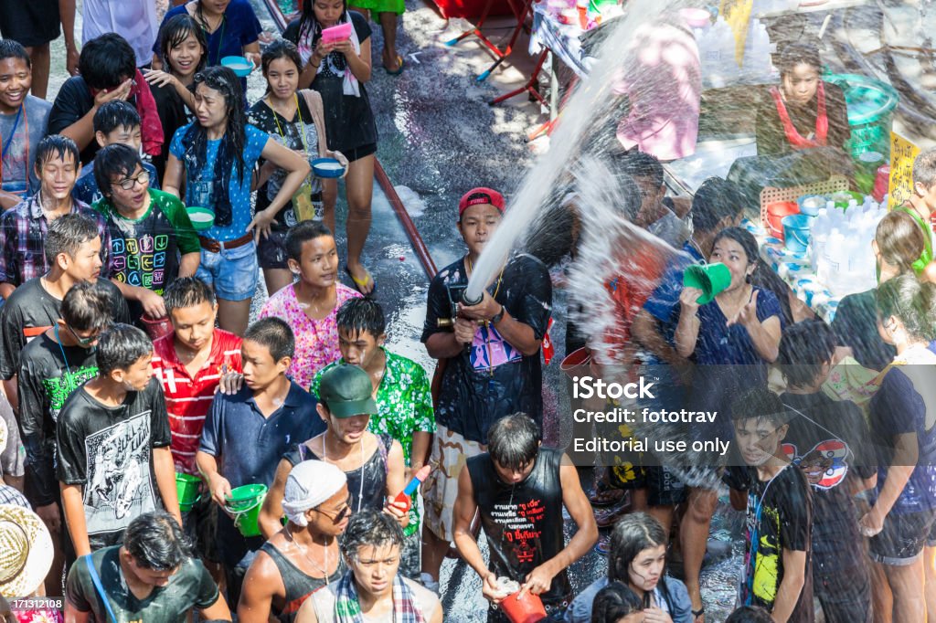 Songkran Water Festival in Bangkok, Thailand "Bangkok, Thailand - April 15, 2012: Thai people celebrating Songkran Festival at Silom in Bangkok. Songkran is Thai New Year Celebrations where people are throwing water a each others" Buddhist New Year Stock Photo