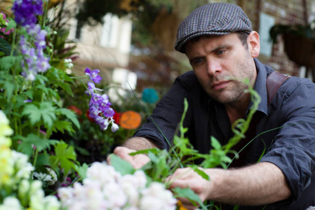 istock handsome mature man with flat cap in a flower shop 171312193