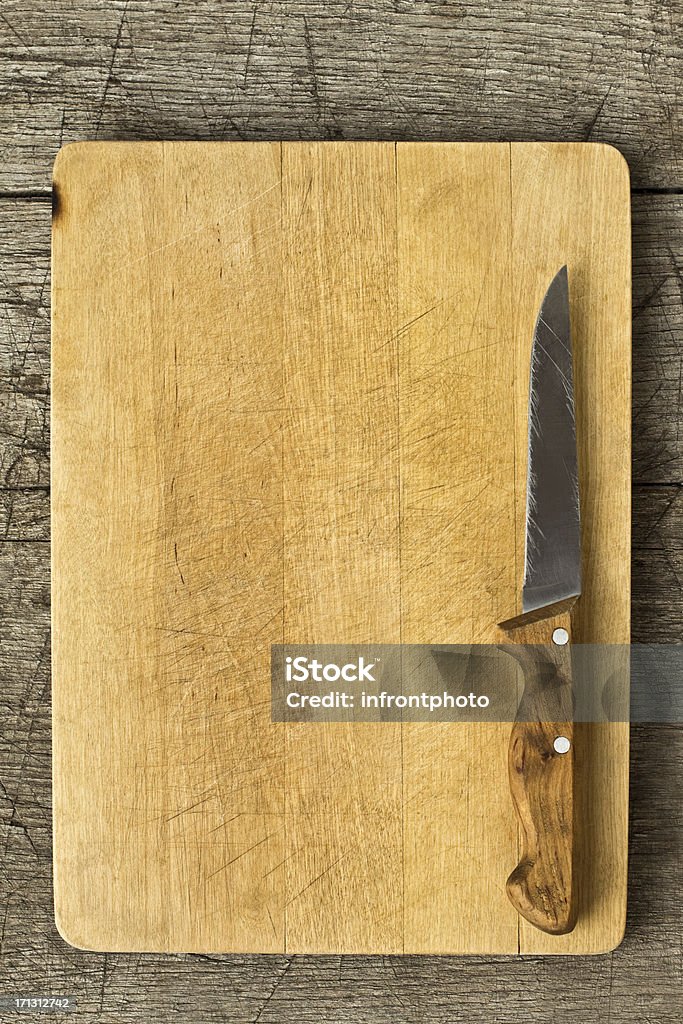 Старый Разделочная доска на деревянном столе - Стоковые фото Кухонный нож роялти-фри
