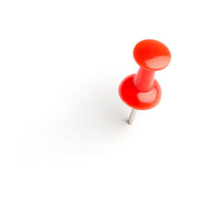 Red push pin isolated on white with a soft drop shadow