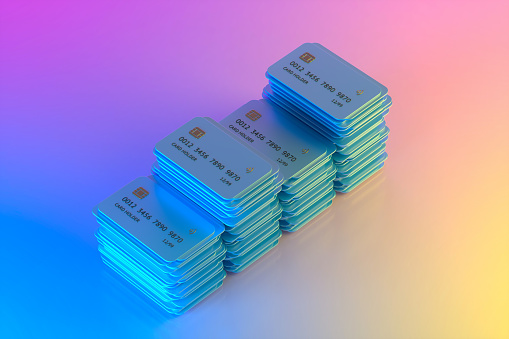 Credit cards on neon background finance and technology concept. Digitally generated image.