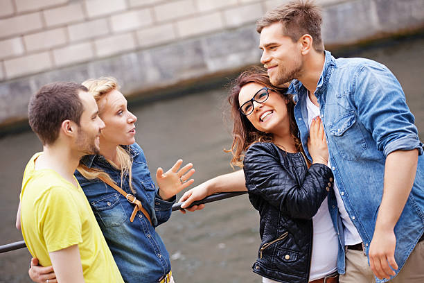 istock two young couples talking outdoors 171313344