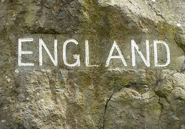 Close-up of an old 'England' sign carved into rock and painted white, located at the border between Scotland and England.
