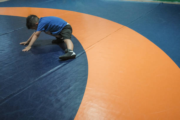 istock A teenager is stretching, preparing for his wrestling training 1713135764