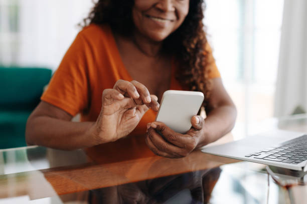 Cheerful senior woman using a mobile app on her smartphone
