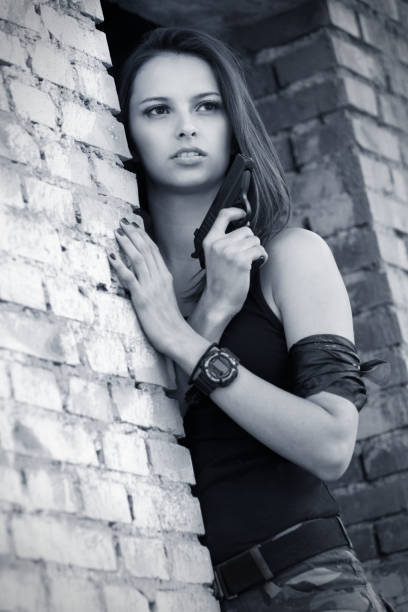 istock beautiful woman with gun 171313734