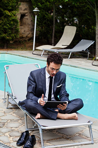 Vurdering homoseksuel bremse Businessman Working With Tablet Closed To A Swimming Pool Stock Photo -  Download Image Now - iStock