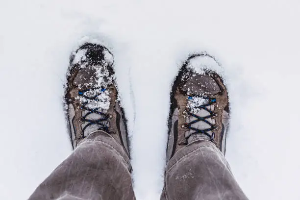 Mountain boots on the snow, seen from the view of the hiker.
