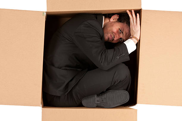 Businessman Packed In A Cardboard Box Stock Photo - Download Image Now -  Stuck, Contortionist, Box - Container - iStock