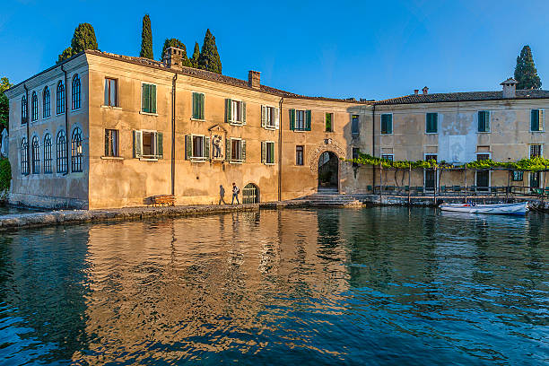 Punta San Vigilio is a small promontory stretching into the lake, surrounded by cypresses and olive trees. It is one of the jewels of Lake Garda, known worldwide for its romantic atmosphere. Lake Garda, Italy.