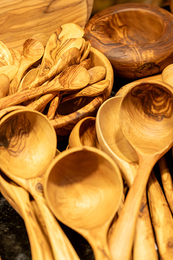 Many wooden cooking spoons and ladles stacked on top of each other to use natural tools in the kitchen