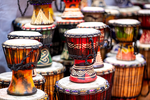 African and Moroccan colorful drums in a store, stacked and in several sizes