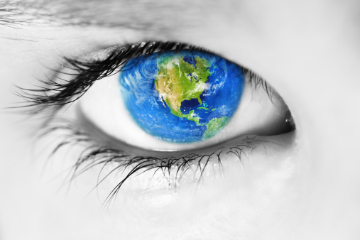 Macro of a child's eye looking at camera with the planet earth and USA in the iris. Earth picture is from NASA http://visibleearth.nasa.gov.