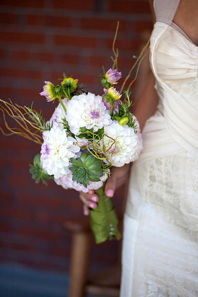 istock Bride holding white and purple bouquet 171314836