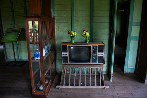 Antique vintage television or old retro  TV on table in living room for thai people and family use watching televisions program in house home  at Phak Hai on September 17, 2023 in Ayutthaya, Thailand