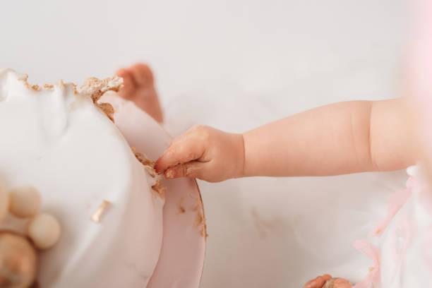 istock Baby hand eating cake 1713151758