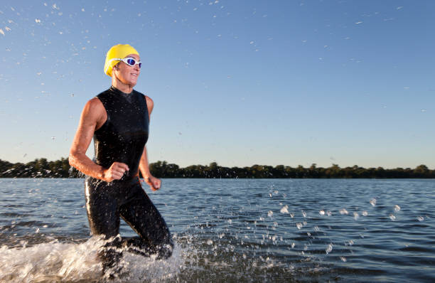 istock Triathlon athlete running in the water 171315268