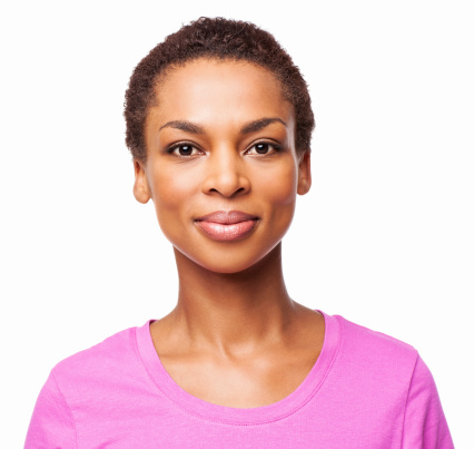 Portrait of a casual African American woman smiling in a pink t-shirt. Horizontal shot. Isolated on white.