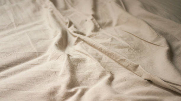 istock Wrinkled cotton sheet in bed 1713155761